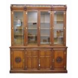 James Winter & Sons, Soho, London An oak bookcase, the lower part with four doors of which two with