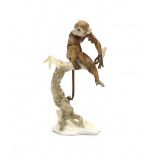 HutschenreutherA porcelain figure of a monkey on a branch, signed underneath with manufacturer's