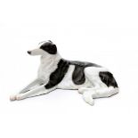 Max Valentin (1875-1935)A porcelain figure of a reclining dog, produced by Rosenthal, Selb, marked.