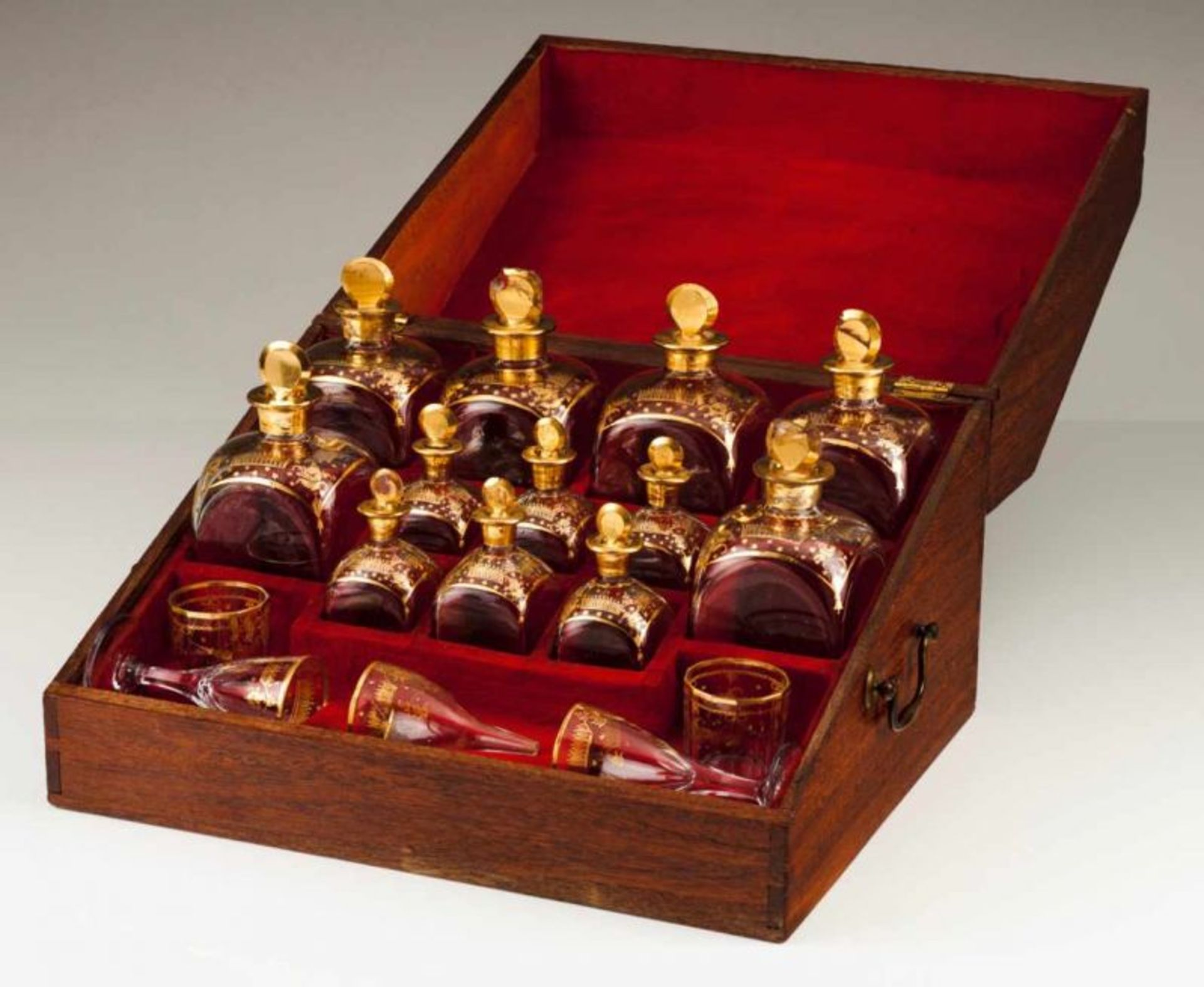 A D. Maria licquor set Oak Twelve glass flasks of different sizes with gilt decoration Comprising