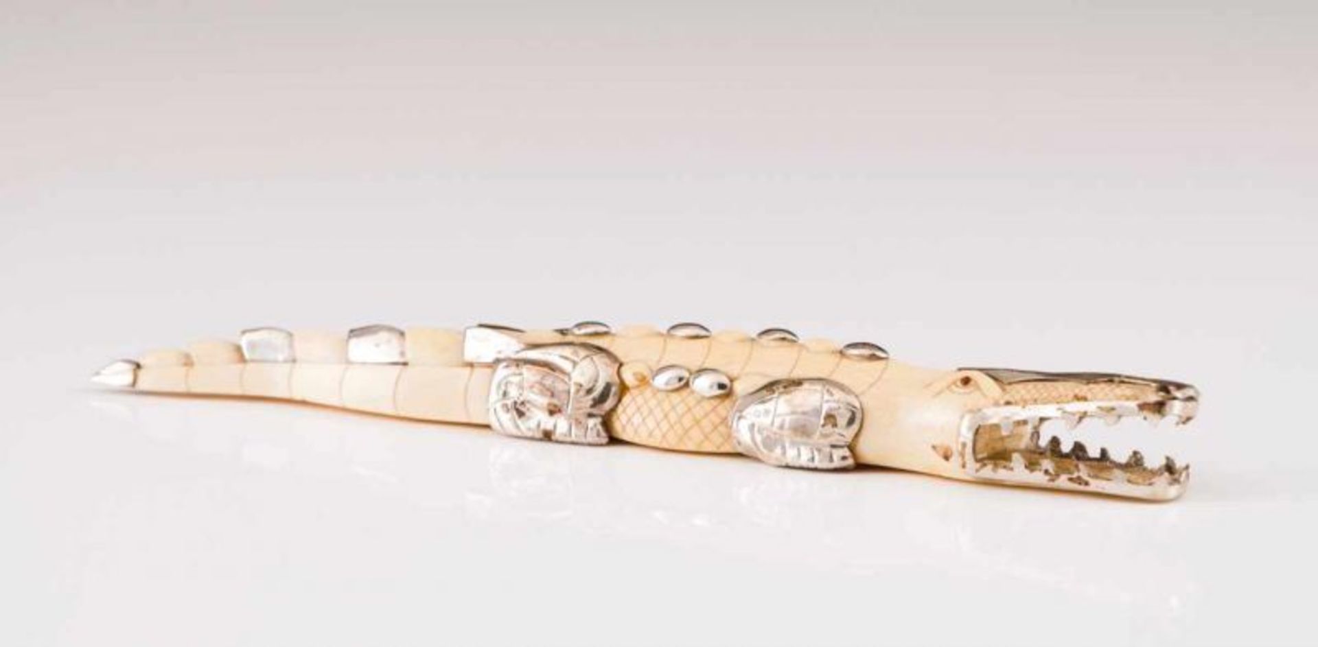 A crocodile, LUIZ FERREIRA A carved ivory and silver sculpture Porto assay mark (after 1985),