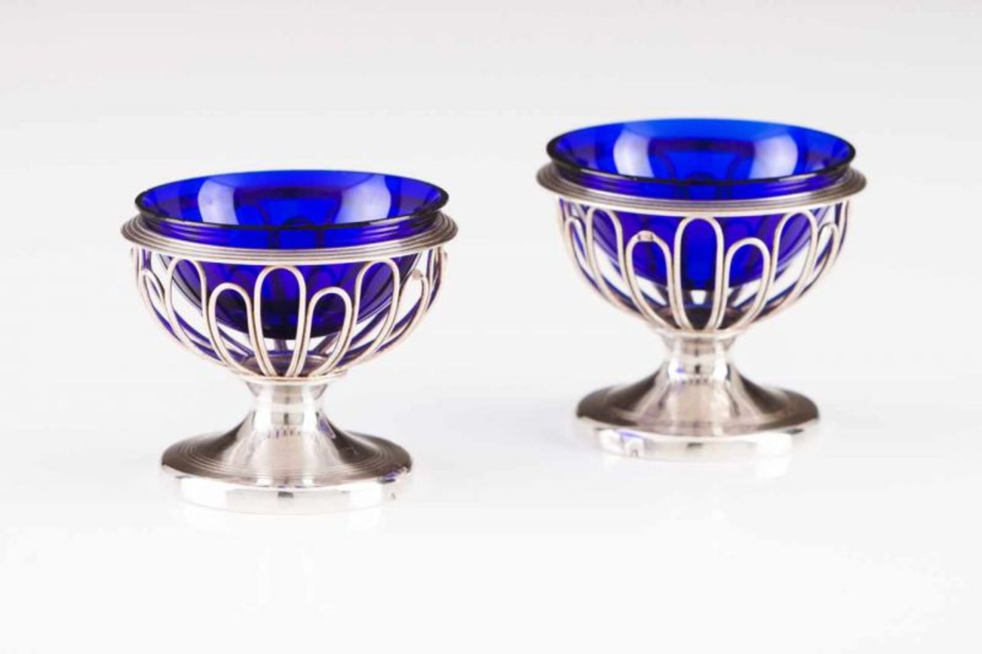 A pair of salt cellars French silver of the late 18th century Silver wire bases, cobalt-blue glass