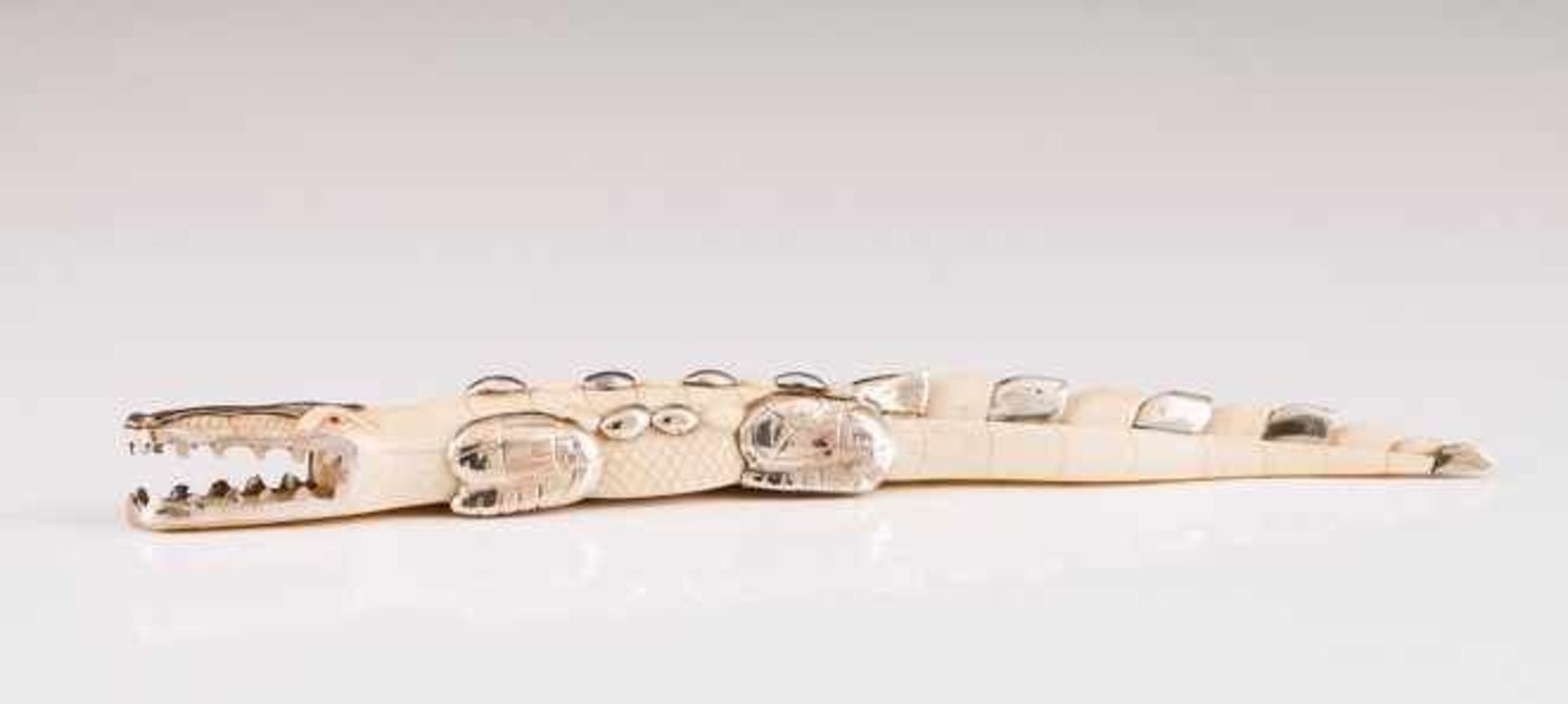 A crocodile, LUIZ FERREIRA A carved ivory and silver sculpture Porto assay mark (after 1985),
