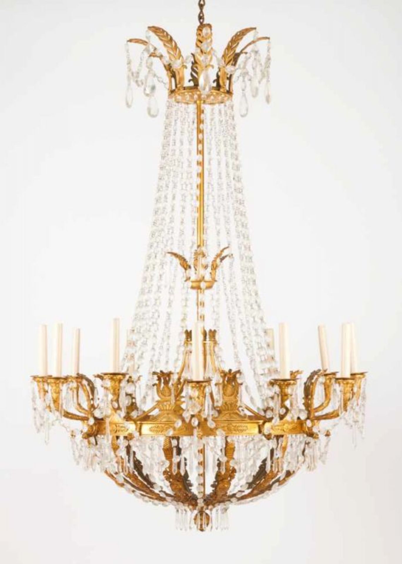 A thirteen-light chandelier in the Empire style Gilt bronze with molded and chiselled decoration