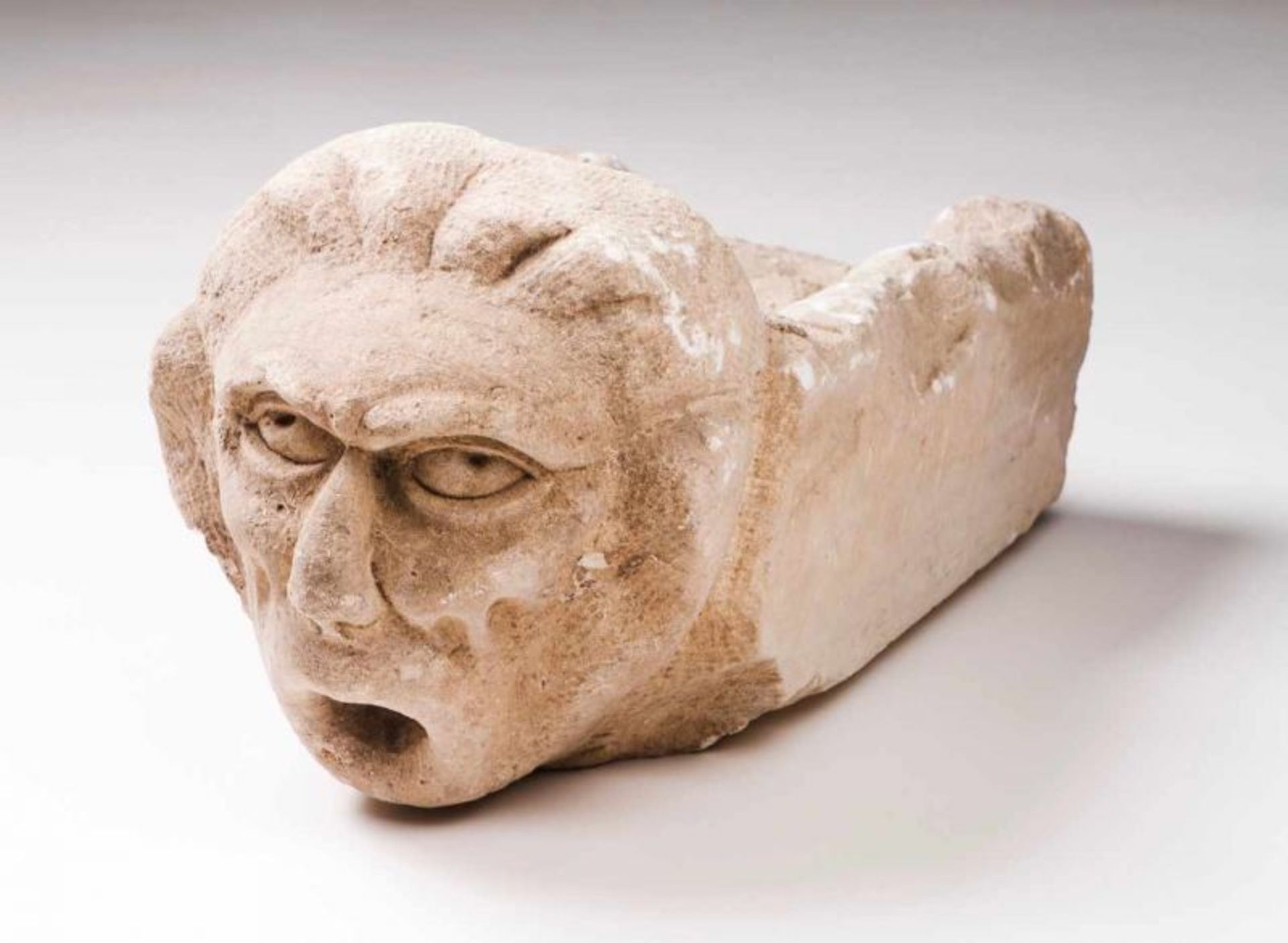 A gargoyle Limestone Carved decoration with head Portugal, 19th century (defects) Length: 52 cm