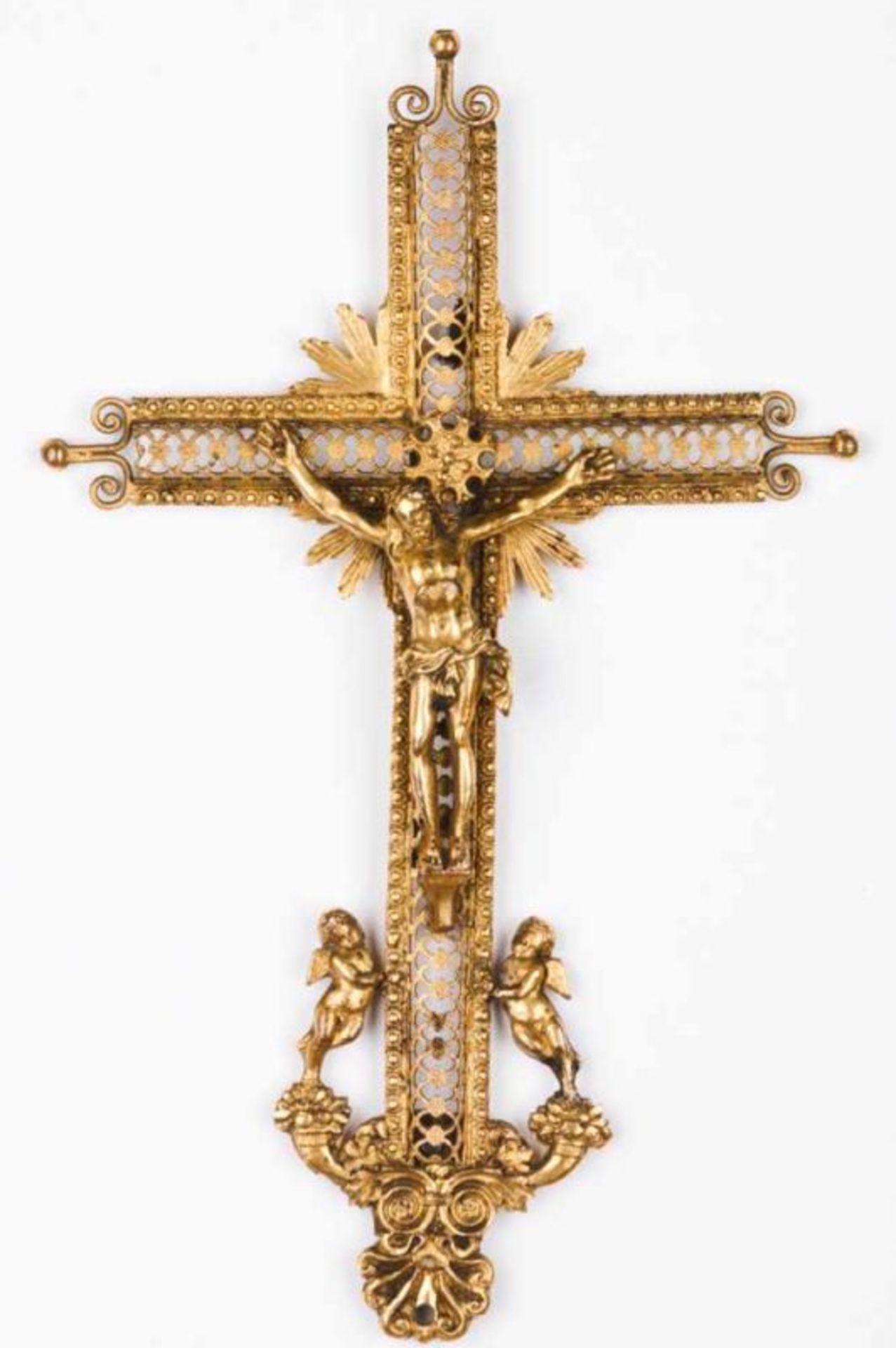 A crucifix Chiselled, engraved and pierced brass Base with angels, floral motifs, volutes and