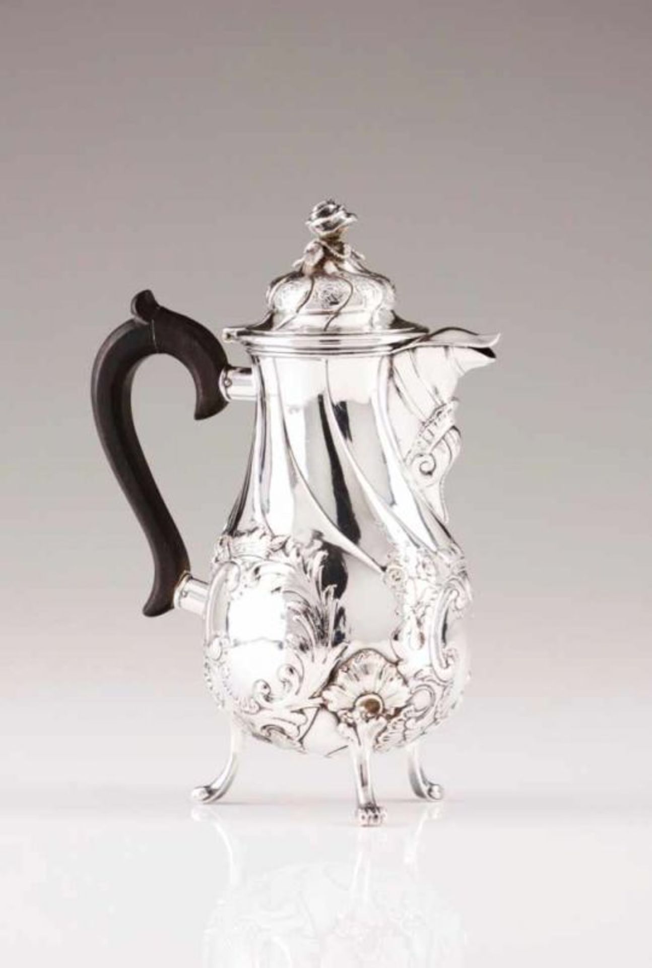 A Rocaille coffee pot Silver decorated in relief, baluster shaped body with spiral fluting and