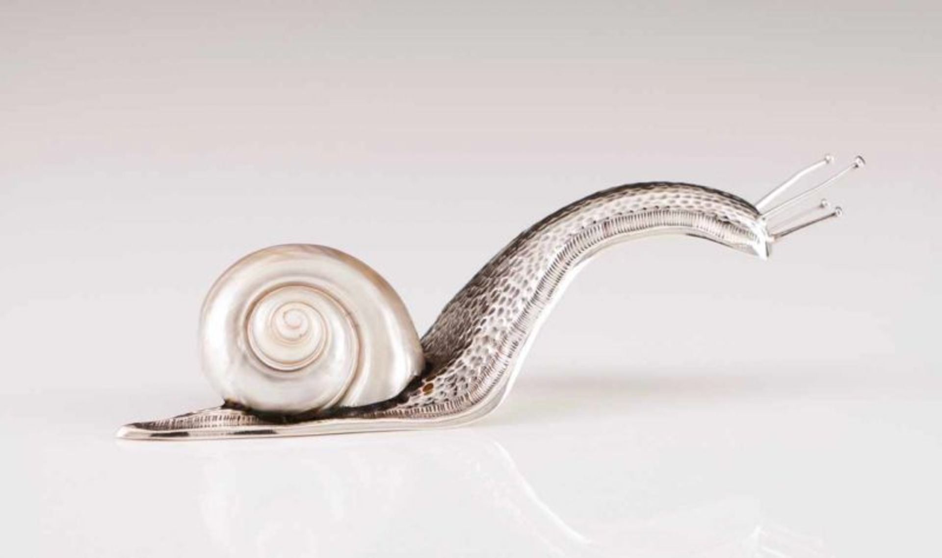 A snail, MANUEL ALCINO A portuguese silver sculpture Hammered decoration and nautilus shell Porto