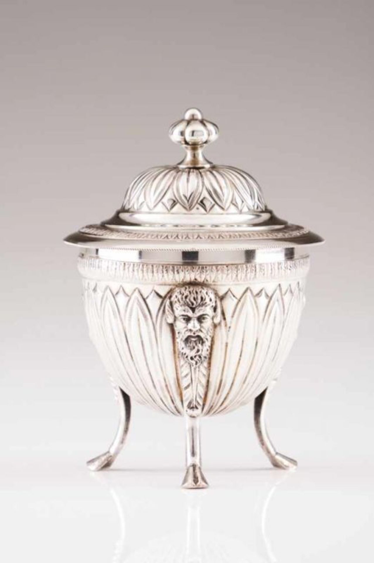 An Empire style sugar bowl Italian silver Raised on three goat feet, legs decorated with masks,