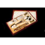 A sweing set Mother of pearl, gilt metal, steel and cut crystal instruments Comprising: scissors,