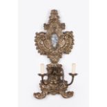 A pair of wall-lights Designed bouquets Silvered metal sheet Relief decoration Height: 72 cm