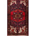 A Persian carpet Cotton and wool Geometric decoration in red, white and blue 205x105 cm