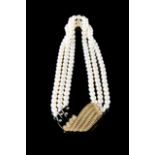 Pearl necklace A three row cultured pearl and diamond necklace Cultured pearls of 7,5mm and onix and
