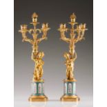 A pair of Napoleon III five-light candelabra Gilt and chased bronze Stems with putti French