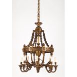 A Louis XVI style chandelier Patinated bronze Fluted and relief decorated France, 20th century