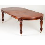 A Victorian style dining table Rosewood, with four extension boards Carved legs with metal castors