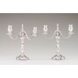 A pair of Romantic two-light candelabra Portuguese silver of the 19th century On four claw feet,