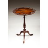 A small tripod table Ebonized wood Carved decoration with floral motifs Ball and claw feet Height: