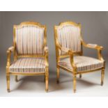 A Louis XVI pair of fauteuils Carved and gilt wood Silk upholstered seats and backs France, 19th