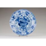 A plate Chinese porcelain Blue decoration depicting precious objects and flowers at the centre