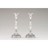 A pair of Romantic candlesticks Portuguese silver of the 19th century Square bases decorated with