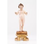 Child Jesus Carved and polychrome wood sculpture Cushion shaped base decorated with flowers Carved