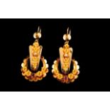 A pair of traditional earrings Traditional gold Scalloped and relief decoration representing