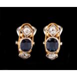 A pair of earrings Set in two-tone gold with two oval cut sapphires and four antique cut diamonds (