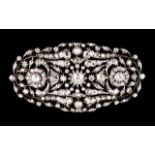 A diamond brooch Silver and gold Pierced and chiseled, decorated with floral motifs and set with