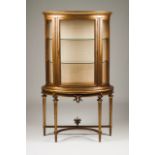 A Louis XVI style demi-lune showcase Gilt wood with carved decoration Interior with glass shelves