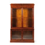 A bookcase Mahogany Two bodies with two glazed doors each and interior with shelves 19th century (