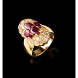 A gem-set ring Set in gold with four oval cut rubies and 28 brilliant cut diamonds (ca. 0,45ct)