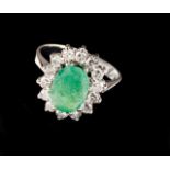 A ring Set in white gold with one oval cut emerald and 14 single cut diamonds (ca. 0,70ct) Assay