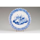 A plate Faience Blue decoration depicting houses Portugal, 19th century (losses) Diam.: 33,5 cm