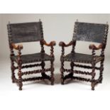 A set of two armchairs Walnut Engraved leather backs and seats with brass pins Decorated with two