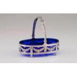 A small oval basket Cobalt-blue glass lining Spanish silver mount and handle decorated in the