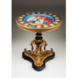 A Napoleon III centre table Ebonized wood Decorated with porcelain plaques and gilt bronze mounts