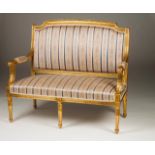 A Louis XVI settee Carved and gilt wood Silk upholstered seat and back Lenght: 122 cm