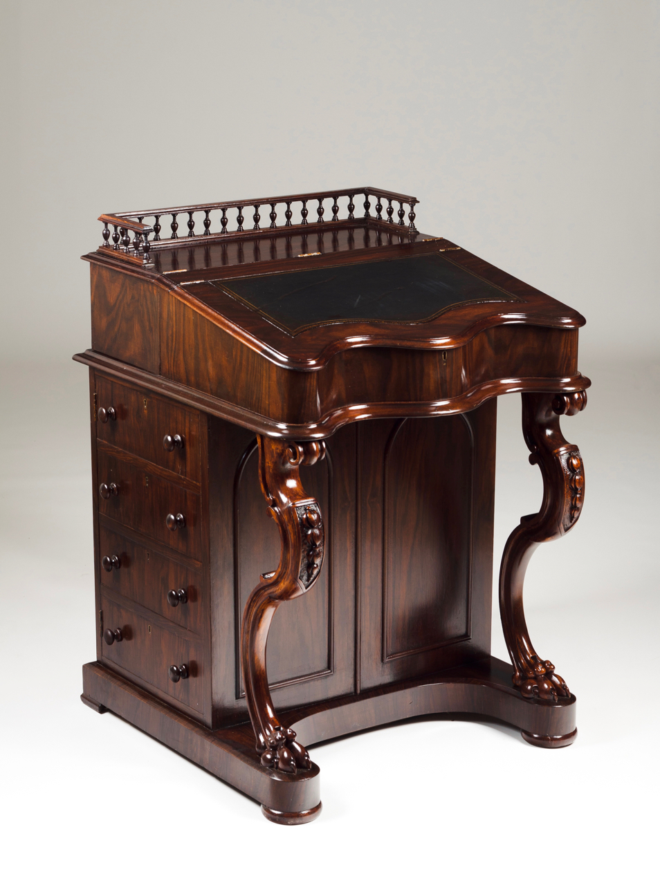 A Victorian Davenport Mahogany Top with gallery and leather lined writing surface Serpentine front