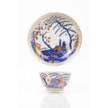 A cup and saucer Chinese export porcelain Rich polychrome decoration in shades of blue, salmon and