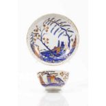 A cup and saucer Chinese export porcelain Rich polychrome decoration in shades of blue, salmon and