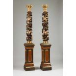 A pair of columns with chapiters Painted and gilt wood plinths decorated with angels, grapes and