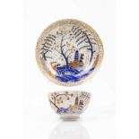 A cup and saucer Chinese export porcelain Rich polychrome decoration in shades of blue, salmon and