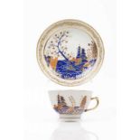 A cup and saucer Chinese export porcelain Rich polychrome decoration in shades of blue, salmon and