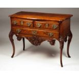 A Rocaille commode Oak and other woods Richely decorated with floral carvings, volutes and shell