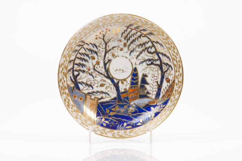 A saucer Chinese export porcelain Rich polychrome decoration in shades of blue, salmon and gold