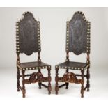 A pair of tall back chairs