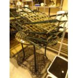 Wrought iron garden table and four matching folding chairs