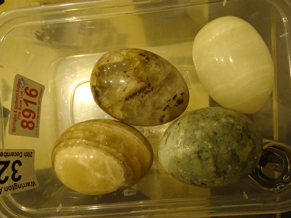 Four polished hardstone eggs