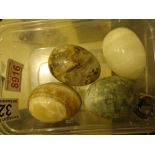 Four polished hardstone eggs